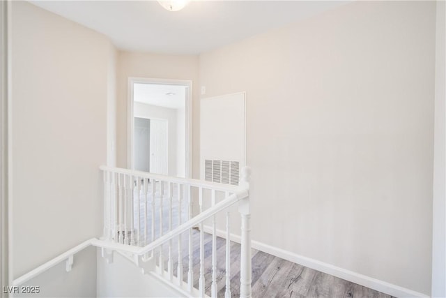 hallway with light hardwood / wood-style floors