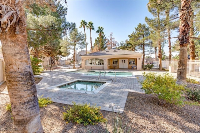 view of swimming pool with a patio area and a hot tub