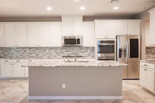 kitchen featuring sink, a center island with sink, white cabinets, and appliances with stainless steel finishes