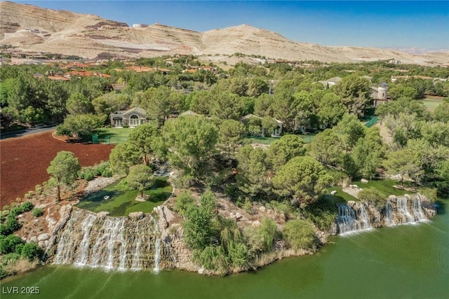 birds eye view of property with a water and mountain view