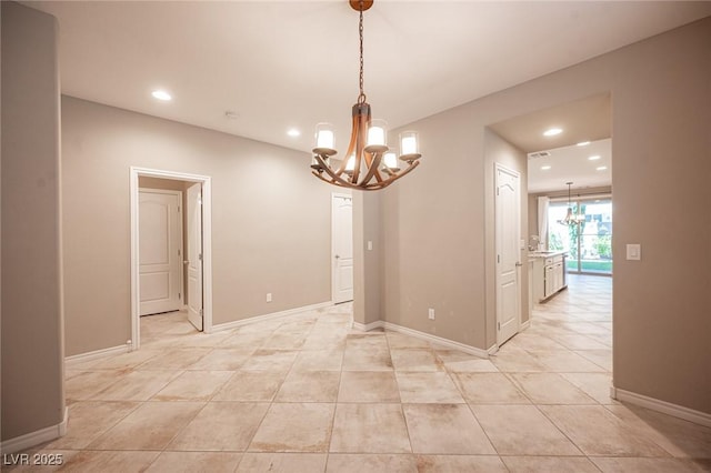 unfurnished dining area featuring a chandelier