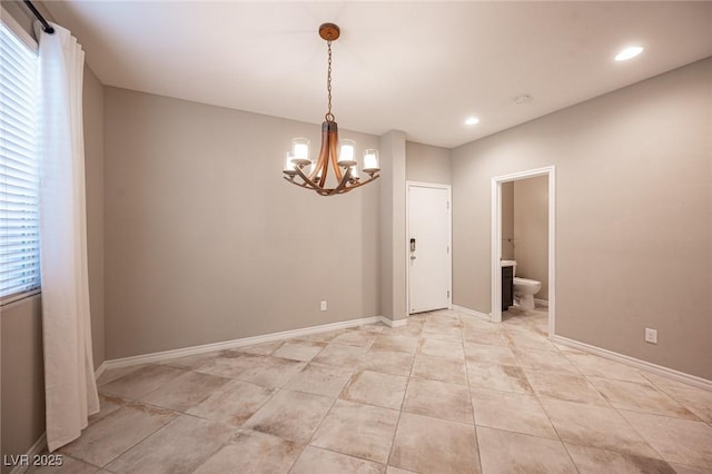 unfurnished room with a notable chandelier