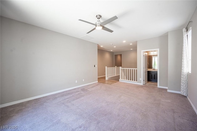 carpeted empty room featuring ceiling fan and plenty of natural light