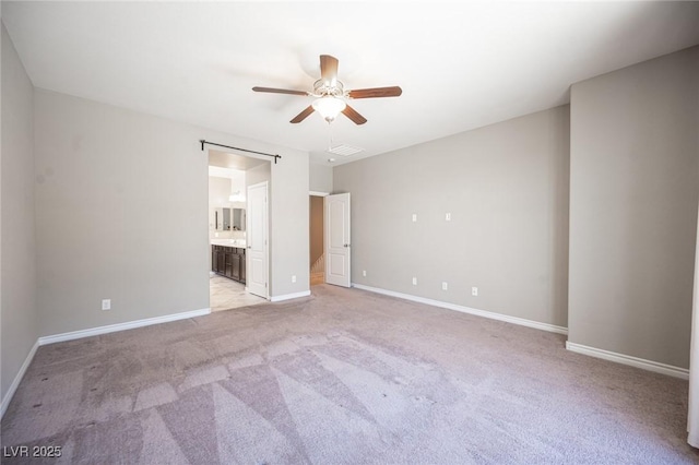 empty room with ceiling fan and light carpet