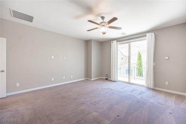 carpeted spare room with ceiling fan