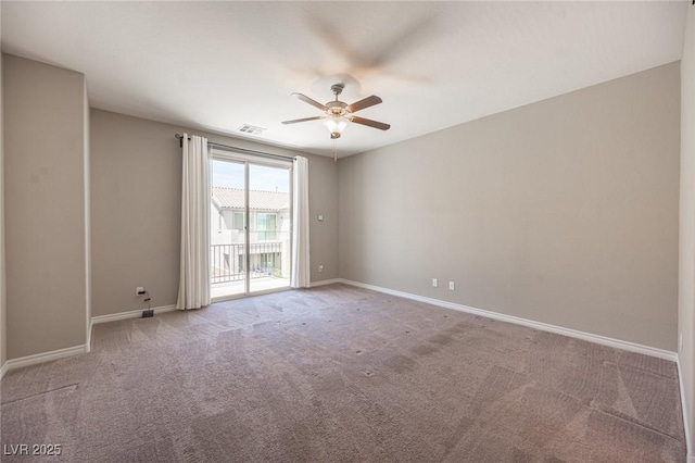 carpeted empty room featuring ceiling fan