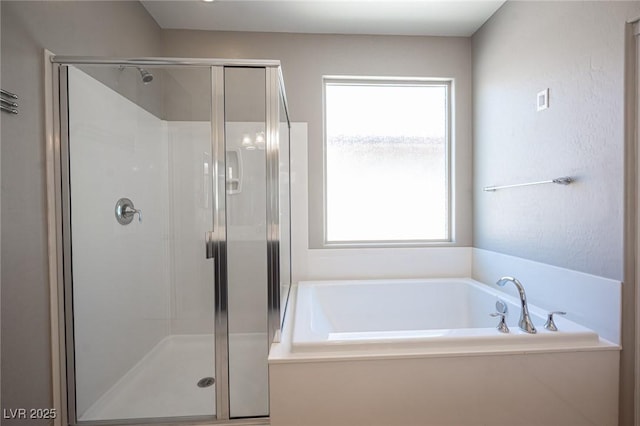 bathroom featuring separate shower and tub