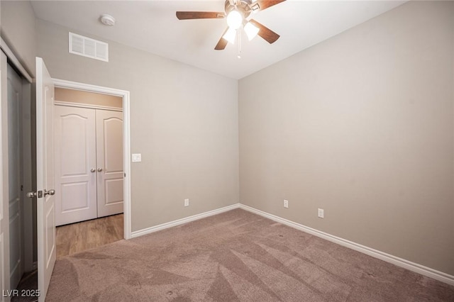 spare room featuring carpet flooring and ceiling fan