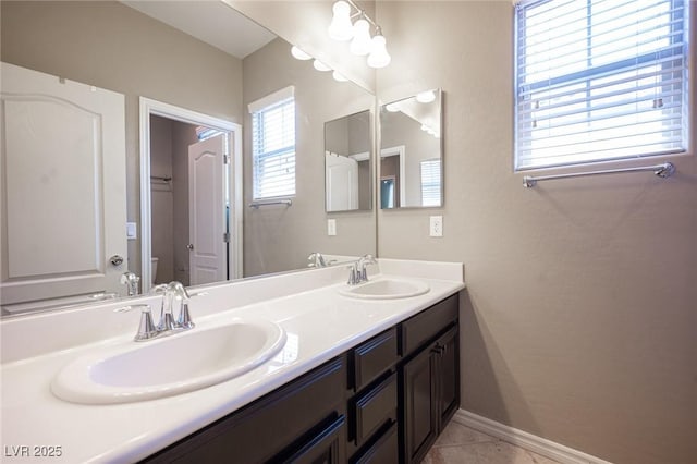 bathroom with vanity, tile patterned floors, and toilet