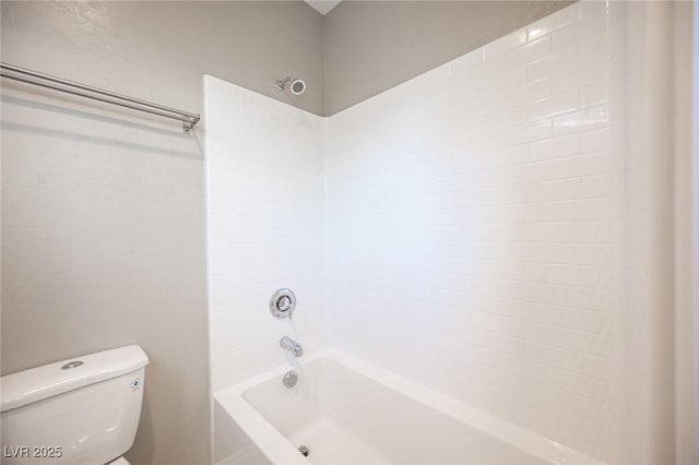 bathroom with toilet and  shower combination