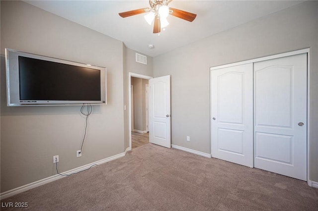 unfurnished bedroom featuring a closet, ceiling fan, and light carpet