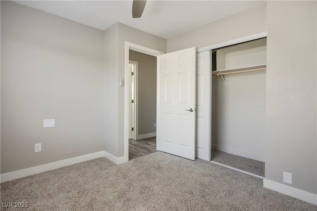 unfurnished bedroom with ceiling fan, carpet, and a closet