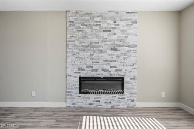 interior details with wood-type flooring and a fireplace