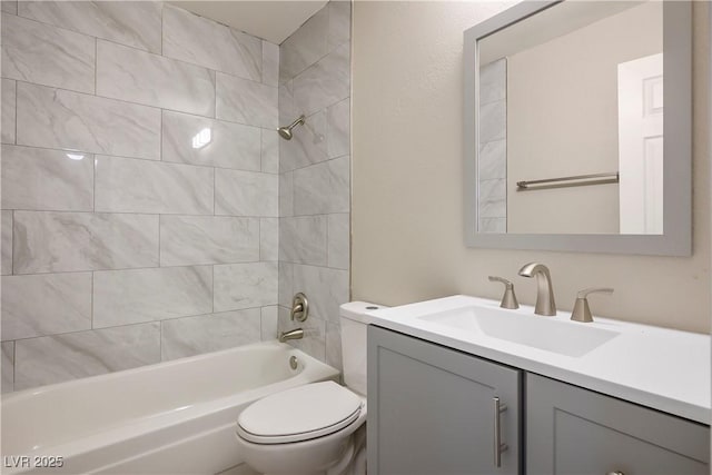 full bathroom featuring vanity, toilet, and tiled shower / bath