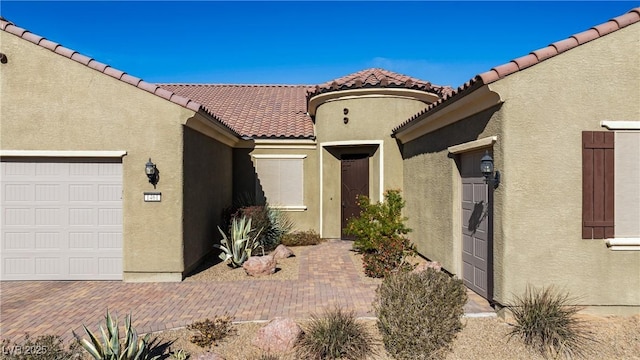 view of exterior entry with a garage