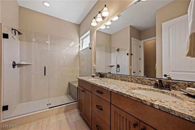 bathroom with an enclosed shower, vanity, and tile patterned floors