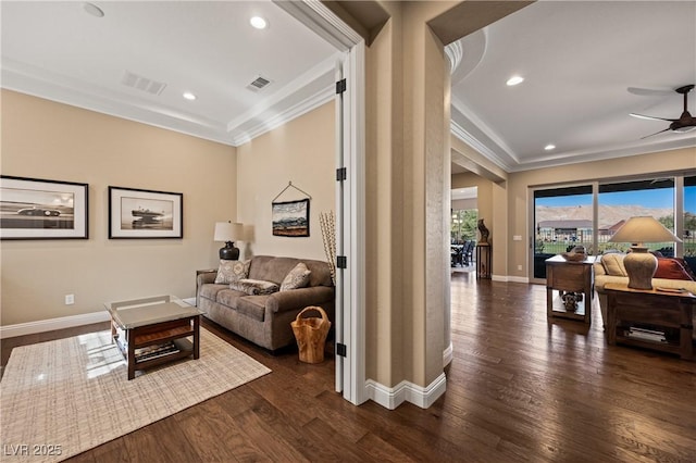 living room featuring dark wood-type flooring, ceiling fan, and ornamental molding