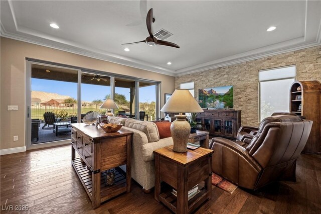 living room with dark hardwood / wood-style flooring, ceiling fan, crown molding, and a mountain view