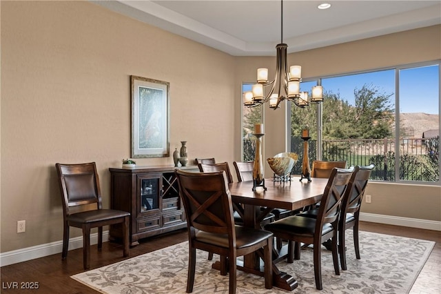 dining space with a chandelier and dark hardwood / wood-style floors