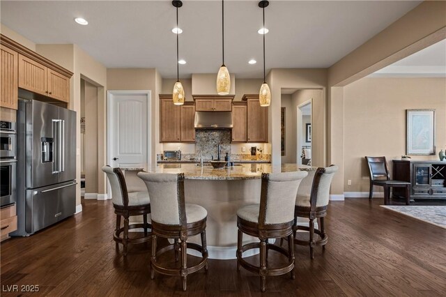 kitchen with stainless steel appliances, dark hardwood / wood-style floors, pendant lighting, and decorative backsplash