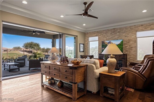 living room featuring hardwood / wood-style floors and crown molding