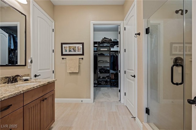 bathroom with vanity and a shower with shower door