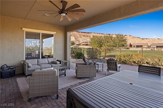 view of patio featuring ceiling fan, a mountain view, and outdoor lounge area