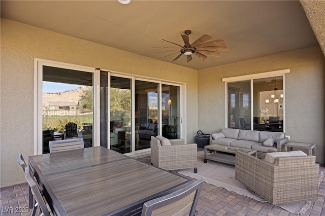 view of patio / terrace with ceiling fan, a mountain view, and outdoor lounge area