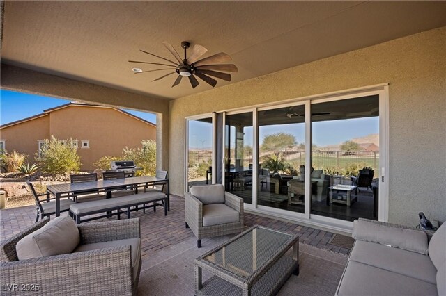 view of patio / terrace featuring an outdoor living space, ceiling fan, and a grill