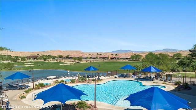 view of pool with a mountain view and a patio