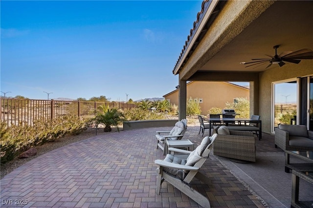 view of patio with ceiling fan and area for grilling