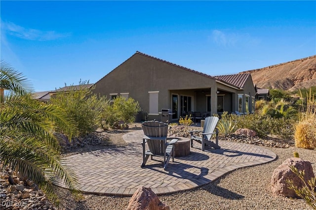 back of house featuring a fire pit and a patio area