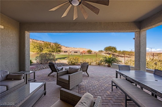 view of patio / terrace featuring ceiling fan and an outdoor living space