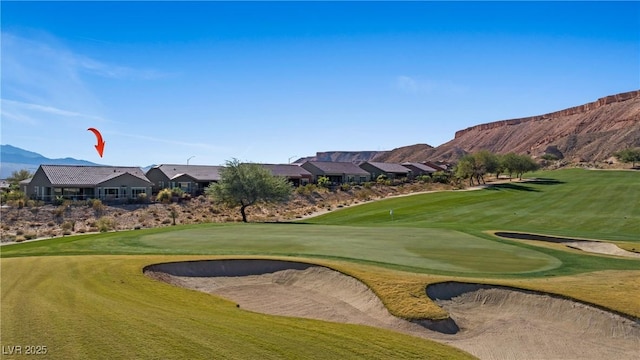 surrounding community with a lawn and a mountain view