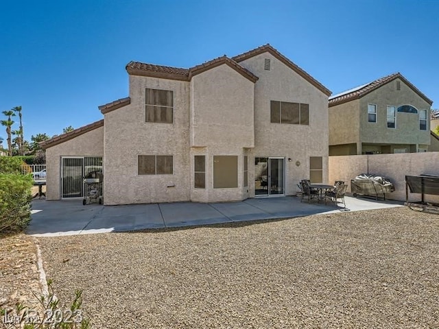 rear view of property featuring a patio