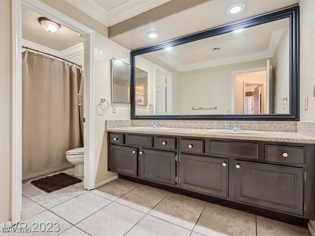 bathroom with tile patterned floors, crown molding, vanity, and toilet