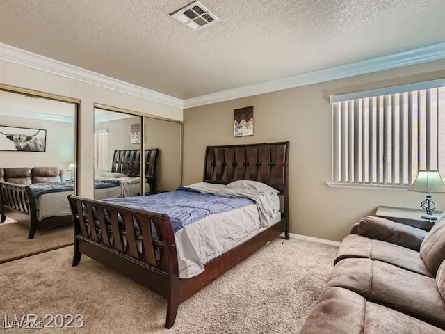 carpeted bedroom with a textured ceiling and crown molding