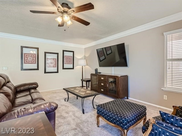 living room featuring ceiling fan, crown molding, and light colored carpet