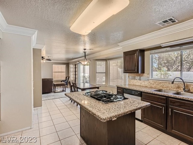 kitchen with sink, stainless steel appliances, a center island, light tile patterned floors, and pendant lighting