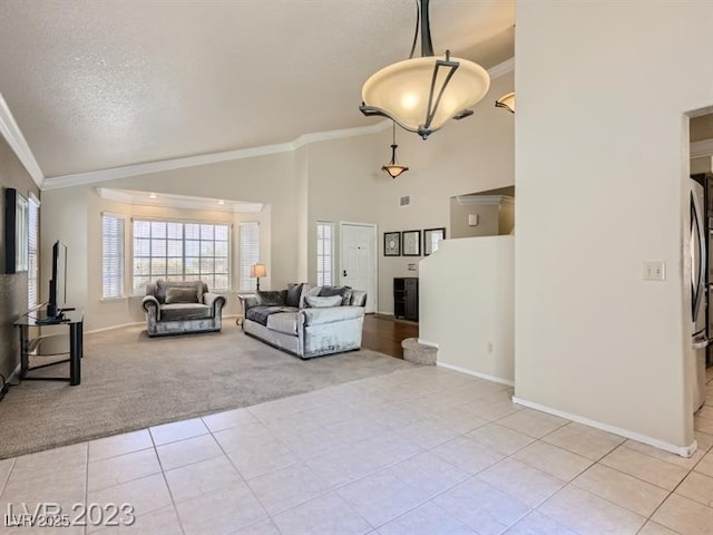 living room with a textured ceiling, light tile patterned floors, and crown molding