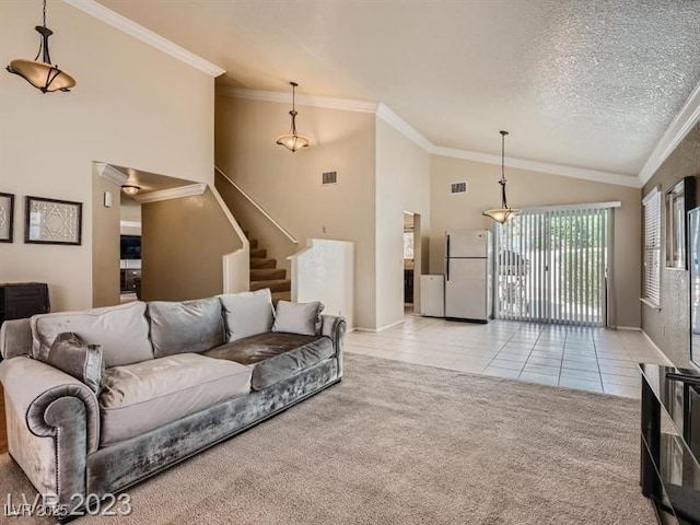 living room with lofted ceiling, crown molding, a textured ceiling, and light tile patterned floors