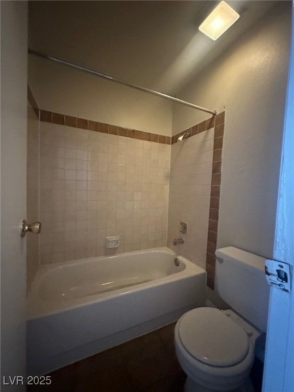 bathroom featuring toilet and tiled shower / bath combo