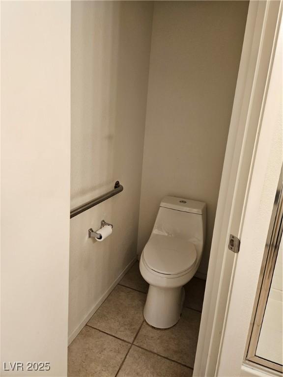 bathroom featuring tile patterned floors and toilet