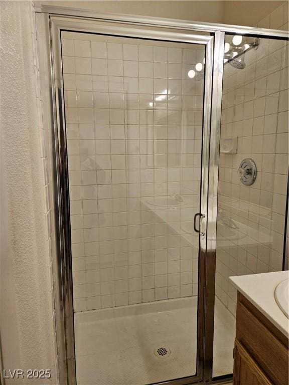 bathroom featuring an enclosed shower and vanity