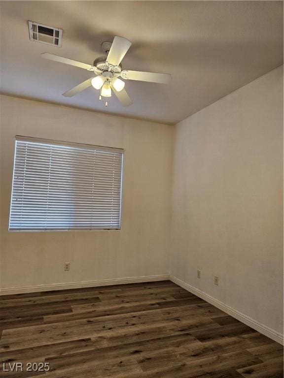 empty room featuring ceiling fan and dark wood-type flooring