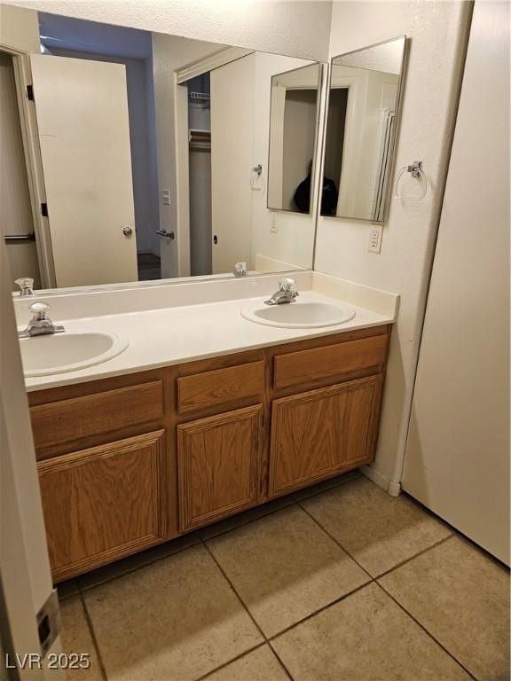 bathroom featuring tile patterned flooring and vanity