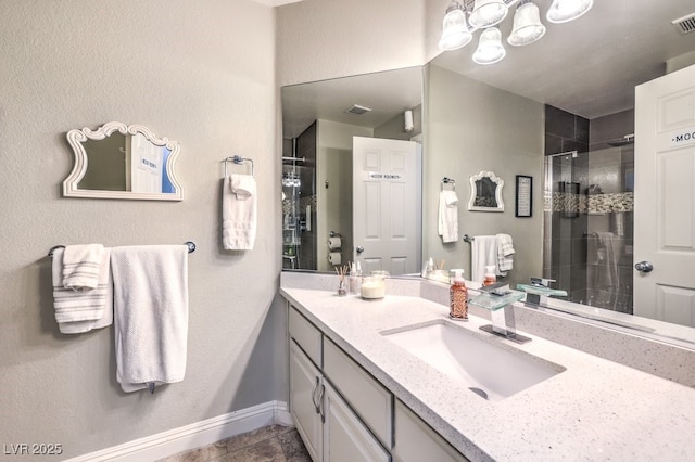 bathroom with tile patterned flooring, a shower with door, and vanity