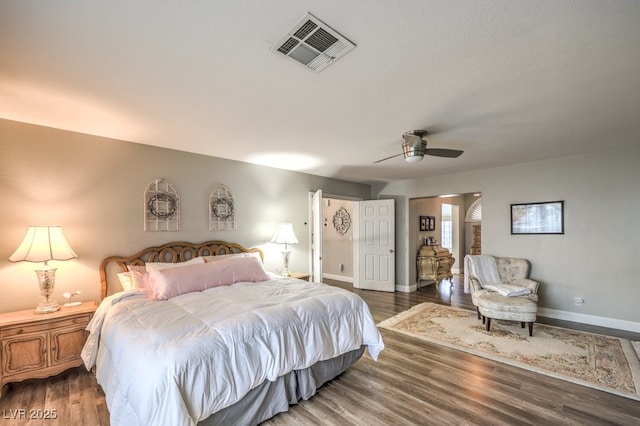 bedroom with ceiling fan and dark hardwood / wood-style floors