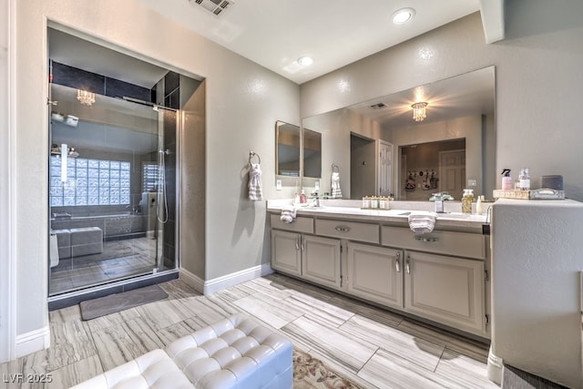 bathroom featuring separate shower and tub and vanity