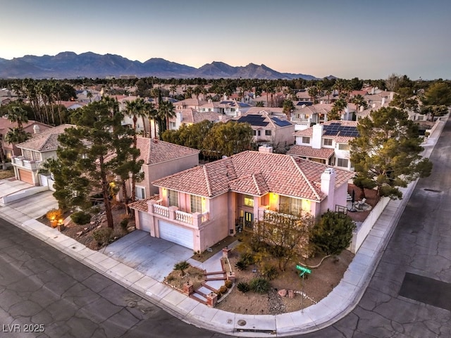 aerial view at dusk featuring a mountain view